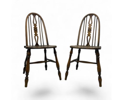 Pair of 20th century elm high back chairs, each with hoop back with pierced central splat, dished saddle seats, raised on tur