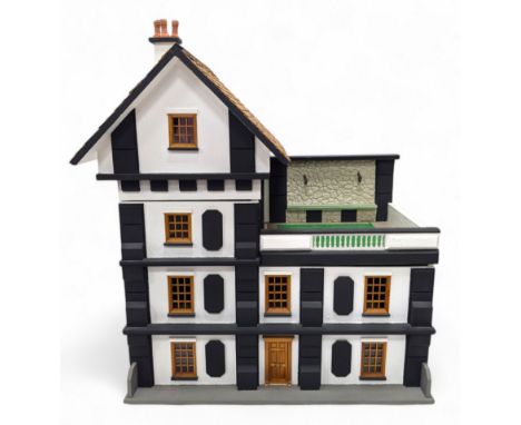 1:24 scale four-storey tudor-style dolls house, with black and white exterior, balcony garden, glazed panelled windows and wo