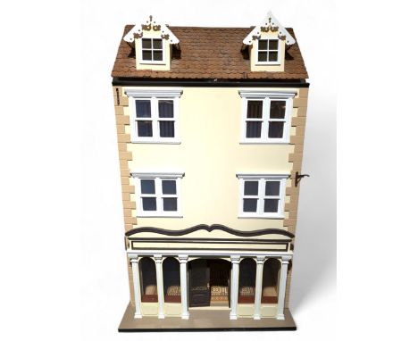 1:12 scale wooden four-storey dolls house with glazed shop front, with brick effect exterior and cream stucco finish under wo