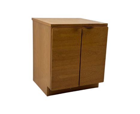 Mid-20th century light oak cabinet, rectangular form with twin cupboard doors and recessed pulls, interior fitted with single