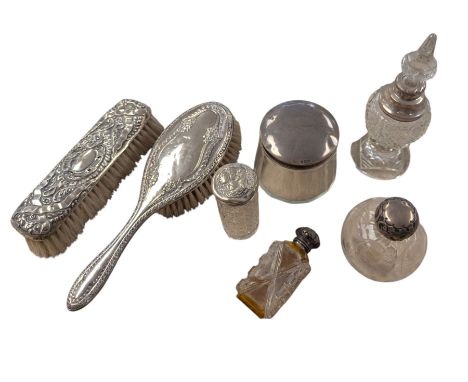 Silver mounted hair brush and clothes brush, four silver topped jars/scent bottles and a scent bottle with silver collar, all