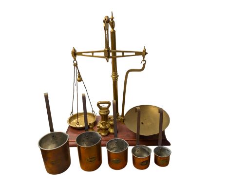 Set of graduating copper measures, set of brass balance scales on wooden base and five graduating brass weights