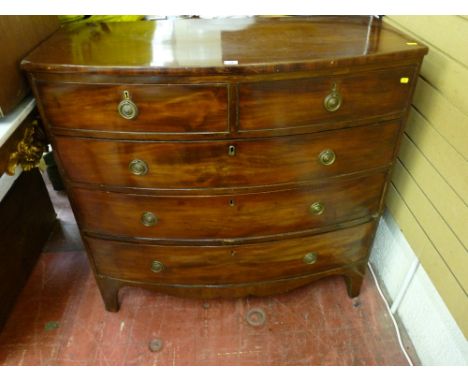 A GEORGIAN MAHOGANY BOW FRONT CHEST of two short over three long drawers, pine lined with circular plate and ring pull handle