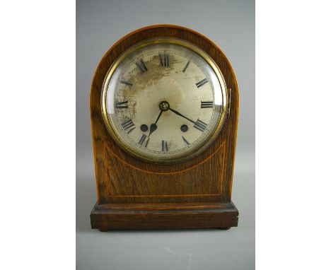AN EDWARDIAN MAHOGANY DOME TOPPED MANTEL CLOCK, the front with boxwood stringing surrounding a silvered dial set with Roman n