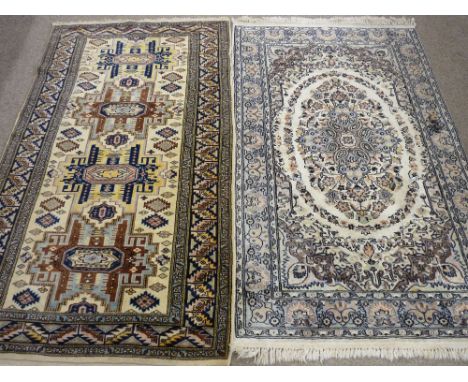 TWO EASTERN PERSIAN STYLE PATTERNED CARPETS in colourful and light muted tones and traditional design, both 162 x 96 cms