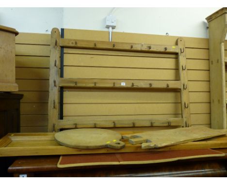 A VINTAGE PINE WITH IRON HOOKS RACK, a bread oven board and one other and a long pine panel, 86 x 114 cms the rack