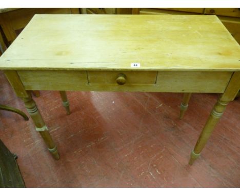 A VINTAGE STRIPPED PINE SINGLE DRAWER SIDE TABLE on turned tapering supports, 73.5 cms high, 90.5 cms wide, 44.5 cms deep