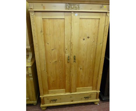 A VINTAGE FRENCH STYLE PINE TWO DOOR ARMOIRE with single lower drawer raised on bun feet, having interior bolts enabling a co