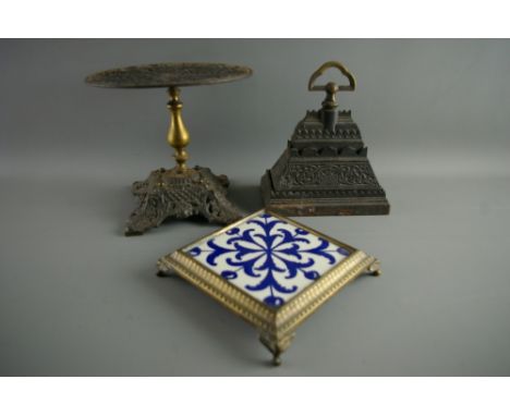 A CAST IRON DOORSTOP & KETTLE STAND with a teapot stand, the doorstop stamped 'A Kenrick & Sons, No. 488', the kettle stand w