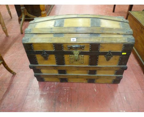 A WOODEN DOME TOPPED TRUNK with iron work strapping and brass lock, 51 cms high, 71.5 cms wide, 41 cms deep