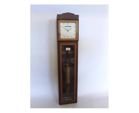Early 20th century and later battery operated electric wall clock, the rectangular case with hinged and glazed square dial wi