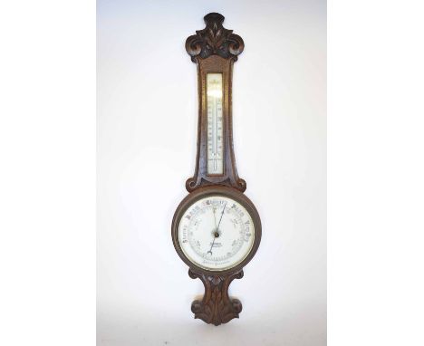 Early 20th century carved oak cased aneroid wheel barometer, retailed by B Bullen - Royal Arcade, Norwich, the carved foliate