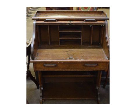 Early 20th century oak framed small tambour fronted desk with open pigeonholed interior, fitted with single full width drawer