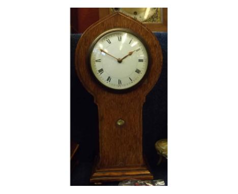 Early 20th century oak cased Art Nouveau style mantel timepiece, the arched and waisted case with copper strung and shell inl