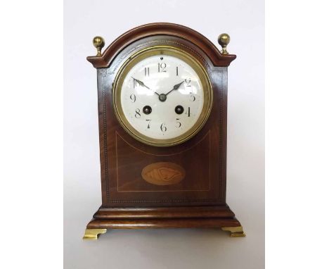 Early 20th century mahogany and boxwood line inlaid mantel clock, the arched case surmounted by four cast brass ball finials 