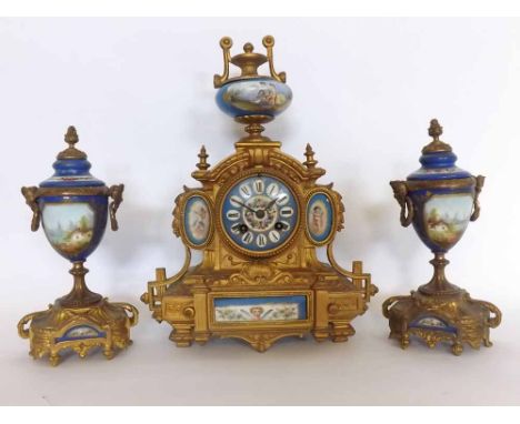 Late 19th century porcelain mounted gilt spelter mantel clock garniture, the case with overhanging cornice surmounted by a li