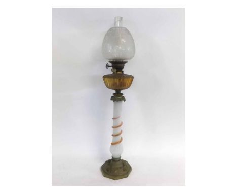 Unusual ornate late Victorian table lamp, the frosted shade over an amber glass faceted font raised on gilt metal mounted opa