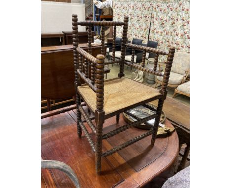 A late Victorian beech bobbin turned rush seat elbow chair, height  90cm.