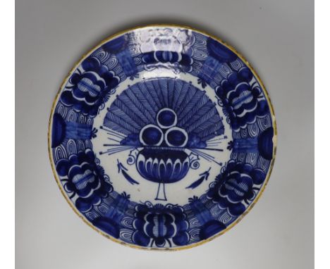 A Dutch Delft blue and white dish, c.1760, painted with the ‘Peacock’ pattern inside and ochre rim, BP mark in blue, rim chip