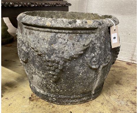 A circular reconstituted stone garden planter, diameter 38cm, height 30cm