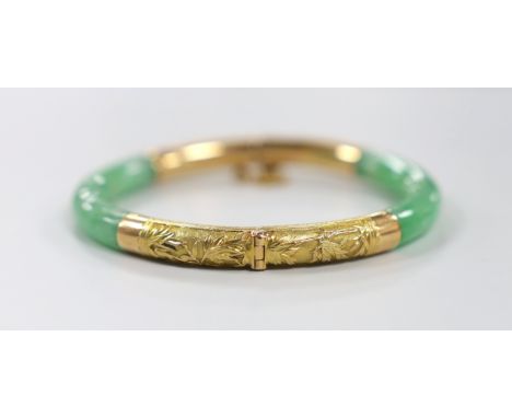 A Chinese 18k yellow metal mounted hinged bangle, interior diameter 57mm, gross weight 29.5 grams.