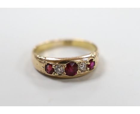 An 18ct and gypsy set three stone ruby and two stone diamond half hoop ring, size Q, gross weight 3.3 grams.