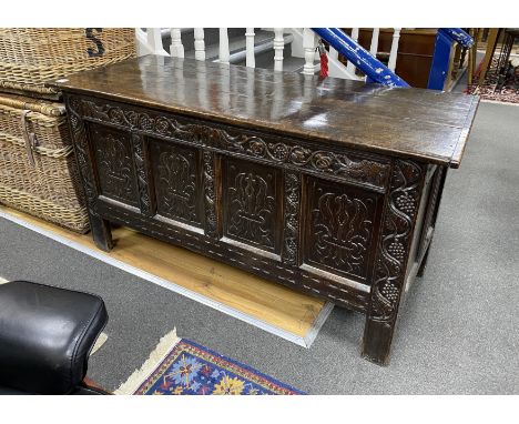 A Charles II carved oak chest, c.1680, with three plank top and four panel front, width 150cm, depth 60cm, height 76cm