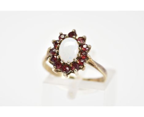 AN OPAL AND GARNET CLUSTER RING, the central oval cut opal and circular garnet surround to a plain polished band, stamped sil
