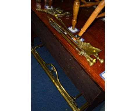 A COLLECTION OF BRASS FIRE ACCESSORIES, to include a fender, width 134cm, five various fire irons and a bellow (7)