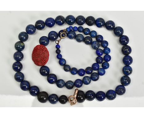 TWO SINGLE ROW LAPIS LAZULI BEAD NECKLACES, the first designed as a near uniform row of spherical lapis lazuli beads, with th