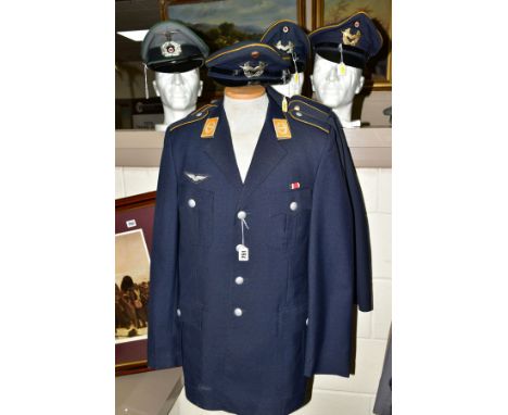 FOUR UNIFORM JACKETS IN THE STYLE OF 3RD REICH WWII LUFTWAFFE, together with four visor caps with insignia (possibly post WWI