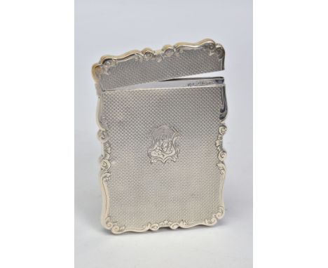 A LATE VICTORIAN SILVER CARD CASE OF WAVY RECTANGULAR OUTLINE, hinged top, engine turned decoration with monogram to shield c