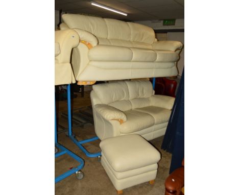 A CREAM LEATHER THREE PIECE SUITE comprising of a three seater settee, two seater settee and a pouffe (3)