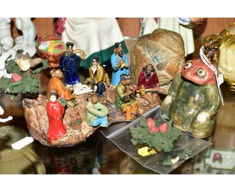 THREE CHINESE/JAPANESE CERAMIC ITEMS, comprising a snuff bottle of toad form, a figural money box and a figure group of the e