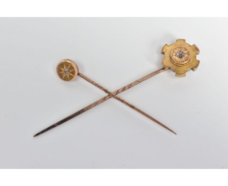 TWO LATE VICTORIAN DIAMOND SET STICKPINS, the first with an old cut diamond in a star setting to the circular panel, the seco