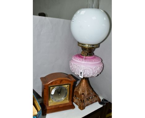 AN ELLIOTT MAHOGANY DOME TOPPED MANTLE CLOCK, having silvered dial, with gilt metal angel decoration to each corner, bevelled