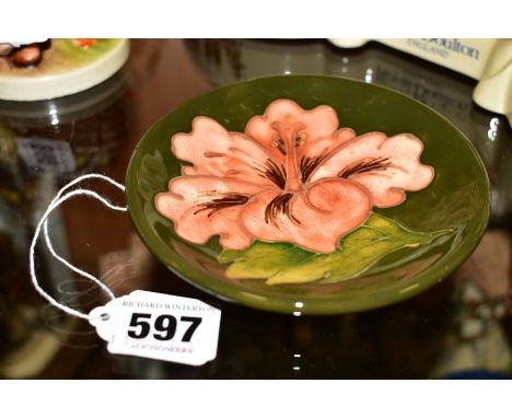 A MOORCROFT POTTERY TRINKET DISH/COASTER, 'Hibicus' pattern on green ground, impressed marks to base, approximate diameter 12
