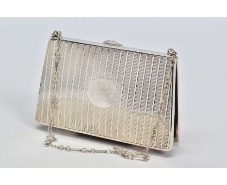 A GEORGE V SILVER PURSE IN THE FORM OF A HANDBAG, engine turned vertical stripes, vacant cartouche, brown leather lined inter