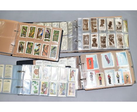 FOUR ALBUMS OF CIGARETTE/TRADE CARDS containing a number of highly collectable 'odds' part sets and complete sets from R J Le