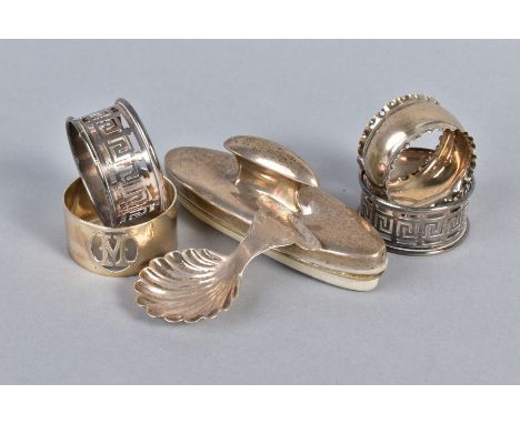 A GEORGE V SILVER SHELL SHAPED CADDY SPOON, Sheffield 1921, together with a silver backed nail buffer, a pair of plated napki