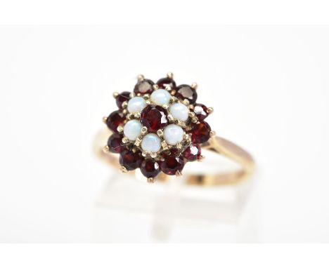 AN OPAL AND GARNET TIERED CLUSTER RING, stamped 9ct, ring size N1./2, approximate weight 4 grams