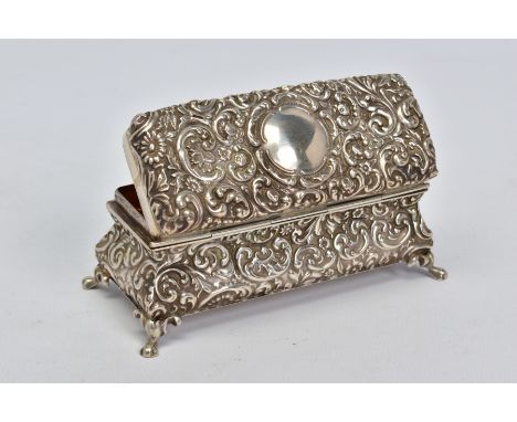 AN EDWARDIAN SILVER TRINKET BOX OF RECTANGULAR BOMBE FORM, foliate repousse decoration, on four cabriole legs, makers Hilliar