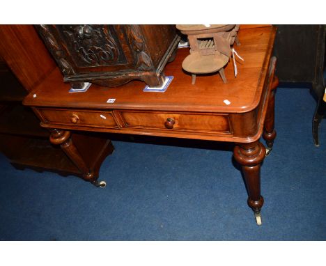 A VICTORIAN WALNUT SIDE TABLE with a raised back, two drawers on four bulbous and cylindrical tapering legs with ceramic cast