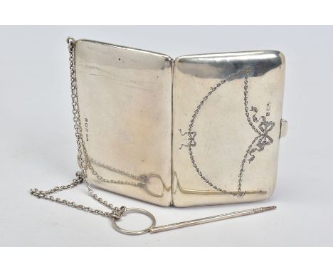 A GEORGE V SILVER RECTANGULAR AIDE MEMOIRE, the front engraved with ribbons and husking, on chain and finger ring, brown leat