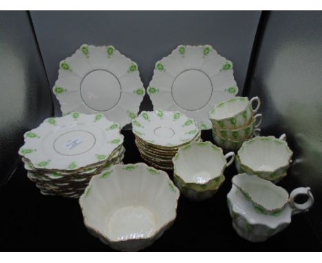 Vintage Paragon China part-tea set with green cameo pattern comprising 2 serving plates, 12 cake plates, 10 saucers, 7 fluted