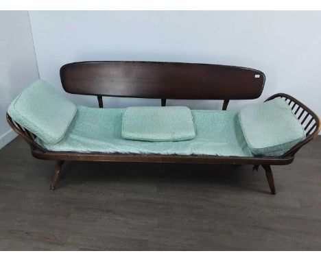 ERCOL SETTEE/DAY BED, dark stained, with cushions The day bed is in a very worn condition and will need a full renovation. Th