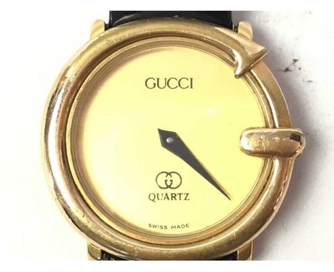 GUCCI, QUARTZ WRIST WATCH,  with champagne dial, on a black strap, lacking box and papers