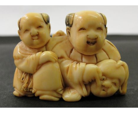 A Japanese Ivory Netsuke:
Meiji period
In the shape of two boys, one of whom is holding a mask
W 4.5 cm CONDITION REPORT: Per