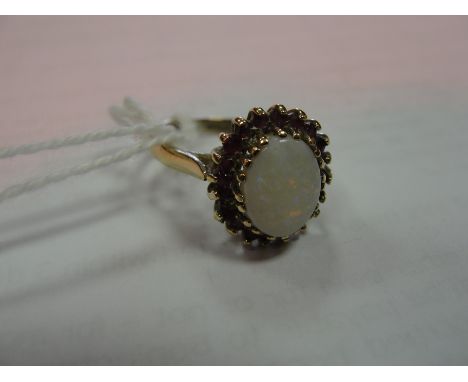 A 9ct opal and ruby dress ring