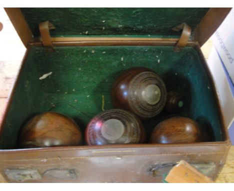 A box of vintage lawn bowls